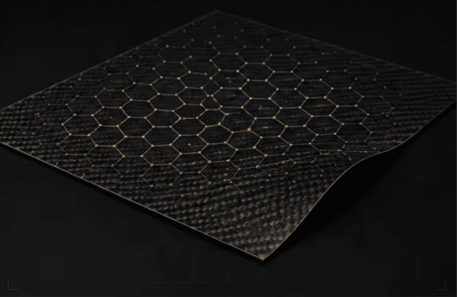 Flexible woven carbon fiber sheet with a glowing golden hexagonal lattice pattern